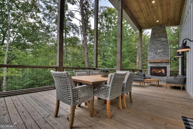 sunroom / solarium with wooden ceiling and an outdoor stone fireplace