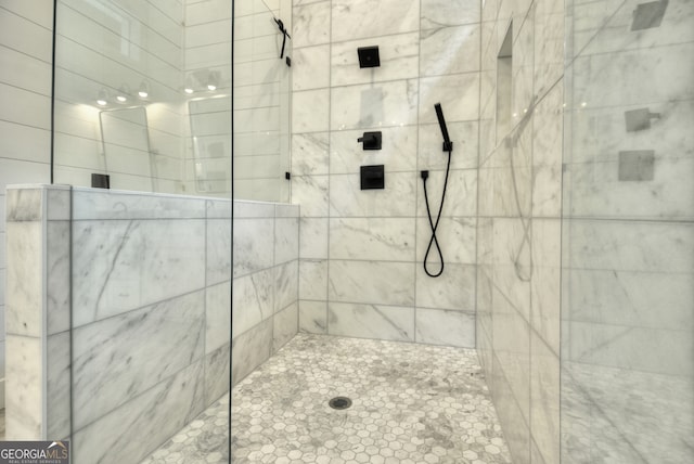 bathroom with tiled shower