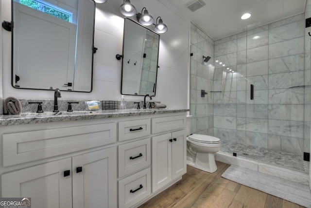 bathroom with a shower with door, vanity, toilet, and hardwood / wood-style flooring