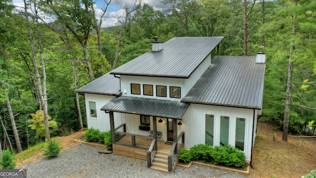 rear view of property featuring a porch