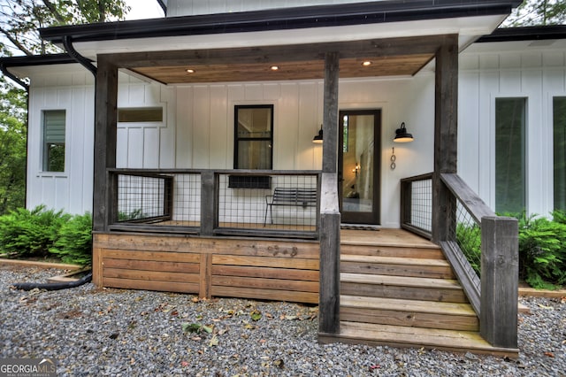 view of exterior entry with a porch