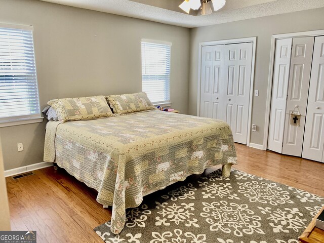 1832 Wayside Rd, Kingston, GA 30145 - bedroom with ceiling fan, two closets, baseboards, wood finished floors, and visible vents