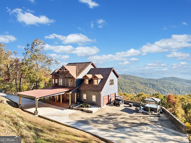 view of front property featuring a mountain view and a patio area