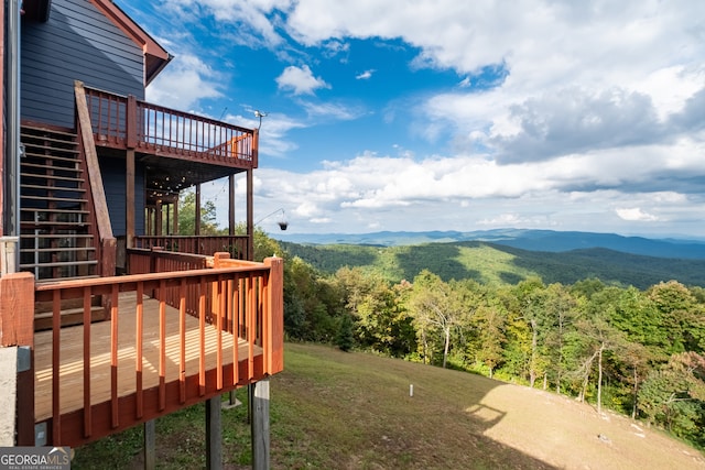 view of yard with a deck with mountain view