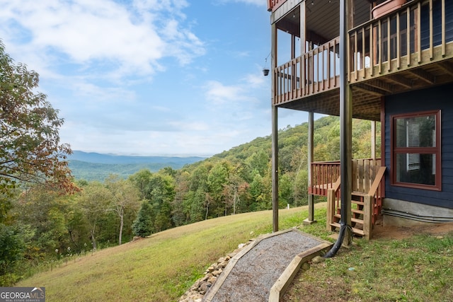 view of yard featuring a deck with mountain view