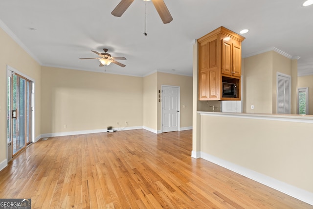 unfurnished living room featuring crown molding, light wood-type flooring, and ceiling fan