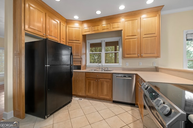 kitchen with ornamental molding, stainless steel appliances, sink, and light tile patterned floors