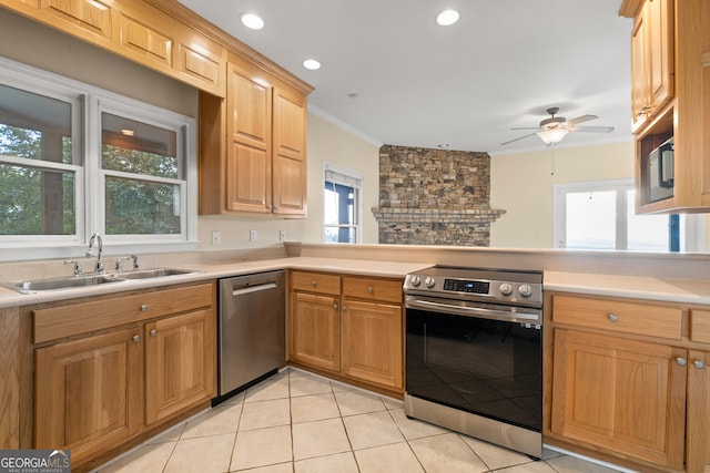 kitchen with appliances with stainless steel finishes, ornamental molding, sink, and a wealth of natural light