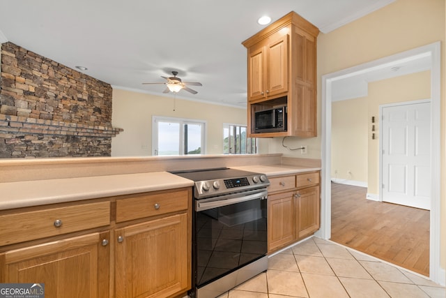 kitchen featuring black microwave, ceiling fan, light wood-type flooring, ornamental molding, and electric stove