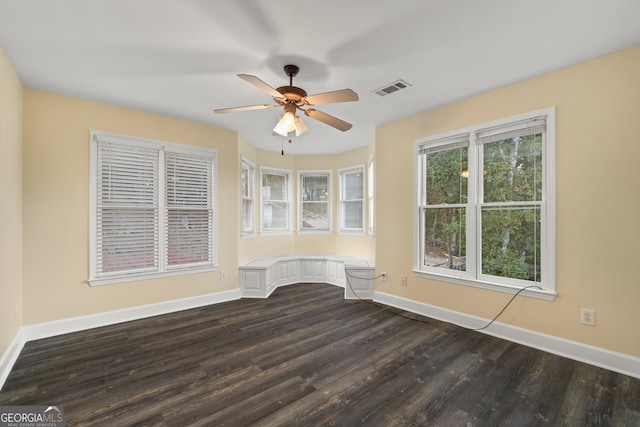 spare room featuring dark wood-type flooring and ceiling fan