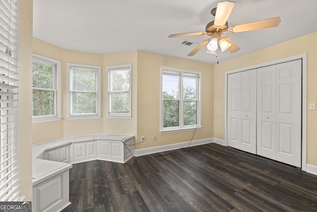 unfurnished bedroom with ceiling fan, a closet, and dark hardwood / wood-style flooring