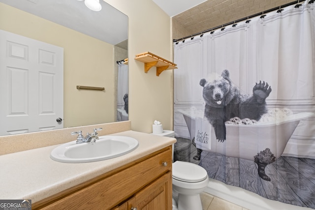 bathroom with walk in shower, vanity, toilet, and tile patterned flooring