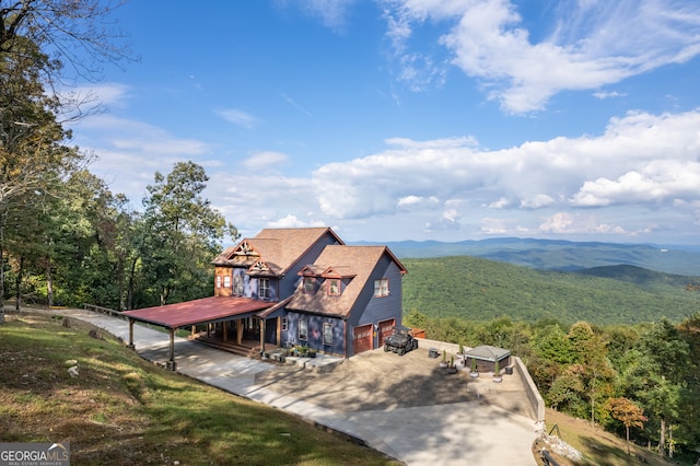 exterior space with a garage and a mountain view