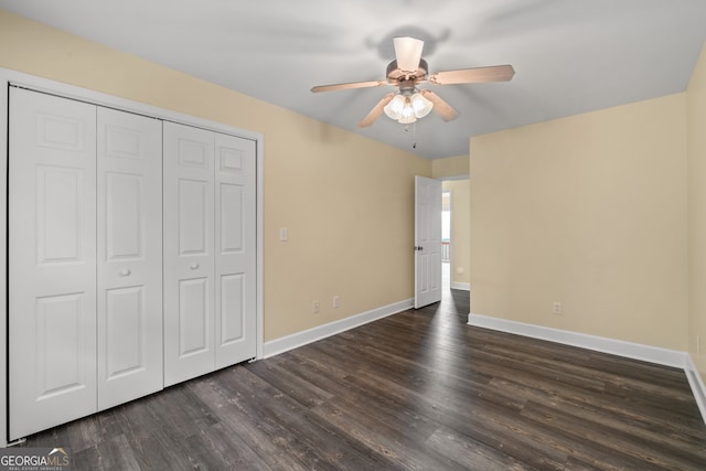 unfurnished bedroom with a closet, ceiling fan, and dark hardwood / wood-style floors