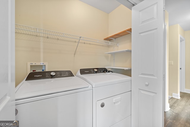 laundry area featuring separate washer and dryer and hardwood / wood-style floors