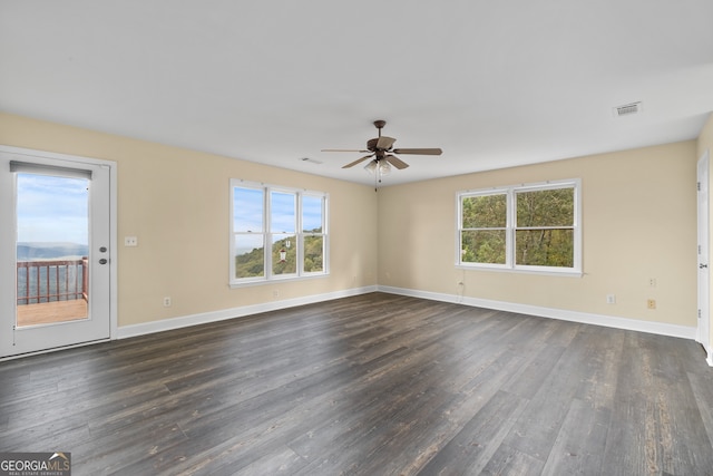 unfurnished room with dark wood-type flooring and ceiling fan