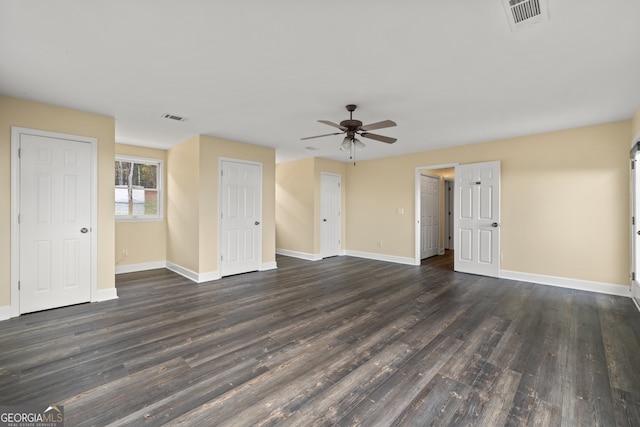 unfurnished living room with dark hardwood / wood-style floors and ceiling fan