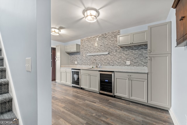 kitchen featuring tasteful backsplash, sink, dark hardwood / wood-style floors, and beverage cooler