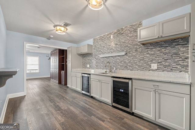 kitchen featuring wine cooler, sink, backsplash, and dark hardwood / wood-style flooring