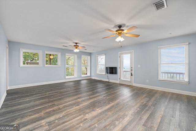 unfurnished living room with dark wood-type flooring and ceiling fan