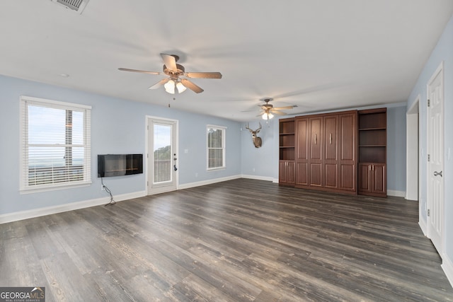 unfurnished living room featuring ceiling fan and dark hardwood / wood-style floors