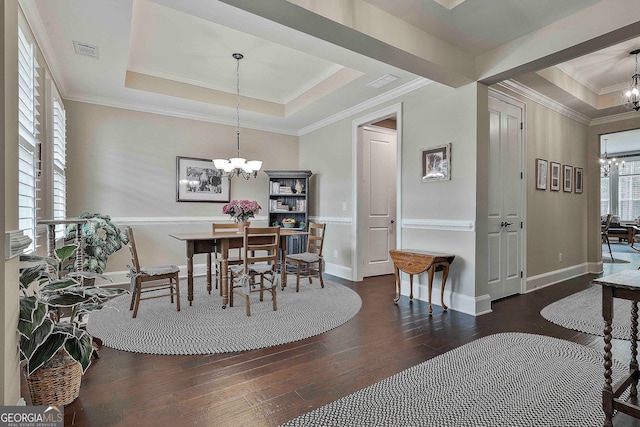 dining area with a raised ceiling, a chandelier, and dark hardwood / wood-style flooring