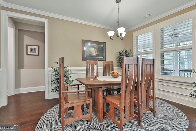 dining area with ornamental molding, a notable chandelier, and dark hardwood / wood-style flooring