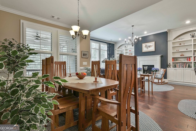 dining area with crown molding, a fireplace, dark hardwood / wood-style floors, and a notable chandelier