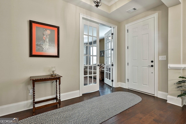 entrance foyer with dark wood-type flooring, french doors, and crown molding