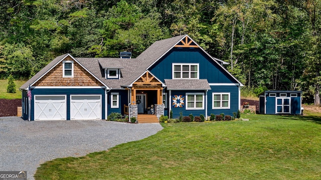 craftsman-style home with a storage shed, a front yard, and a garage