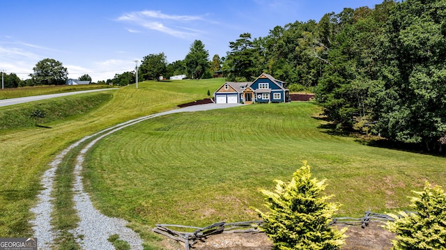 view of property's community with a yard and a garage