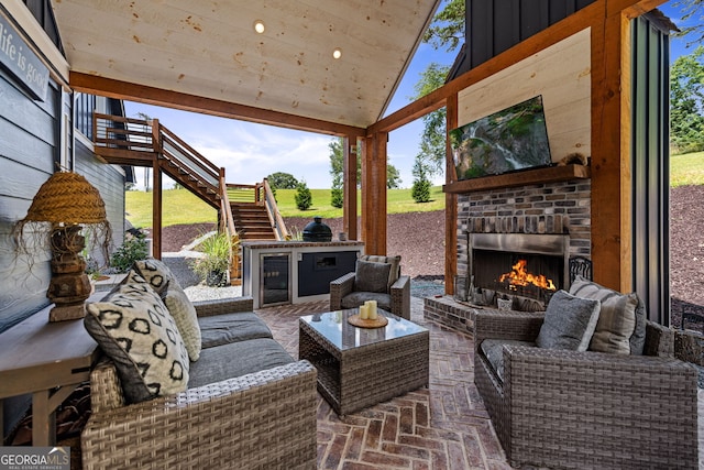 view of patio / terrace with an outdoor living space with a fireplace