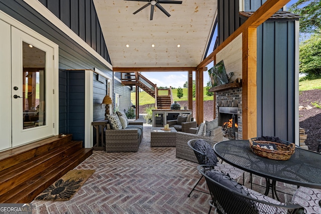 view of patio featuring an outdoor living space with a fireplace and ceiling fan