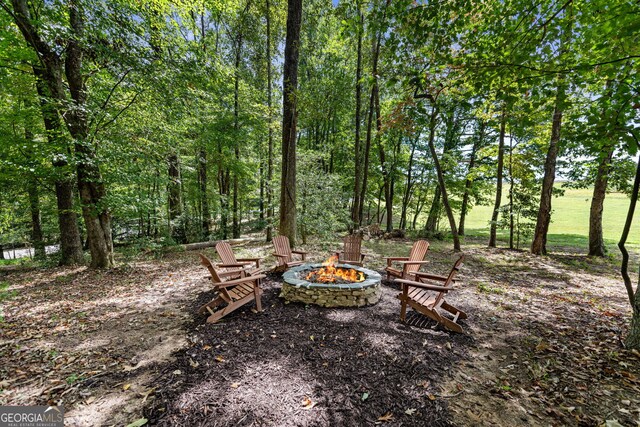 view of yard with an outdoor fire pit