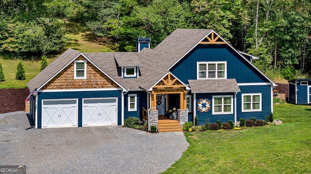 craftsman house with a garage and a front lawn