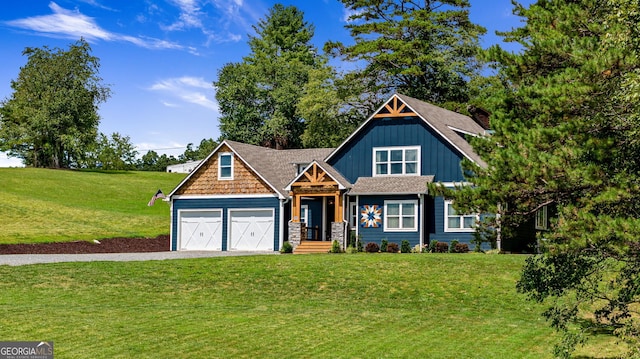 craftsman inspired home featuring a garage and a front lawn