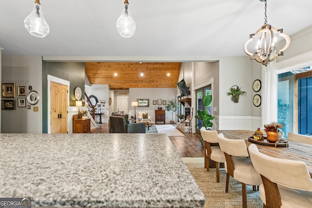 kitchen with hanging light fixtures, hardwood / wood-style floors, and a chandelier