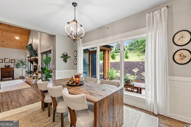 dining space featuring a notable chandelier and light wood-type flooring