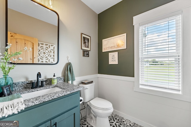 bathroom with vanity, toilet, tile patterned floors, and a wealth of natural light