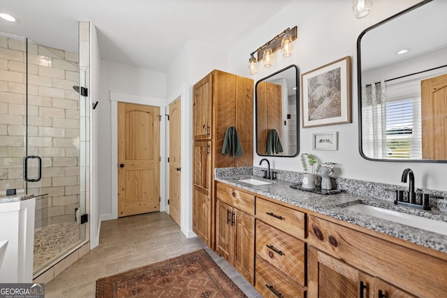 bathroom with tile patterned flooring, vanity, and a shower with shower door