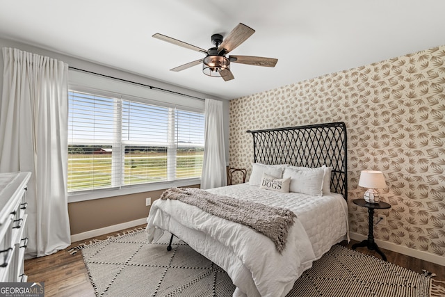 bedroom with ceiling fan and hardwood / wood-style flooring