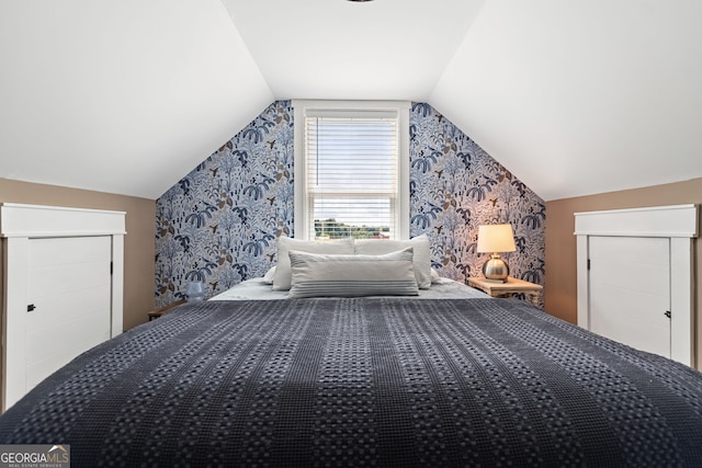 bedroom featuring vaulted ceiling and a closet