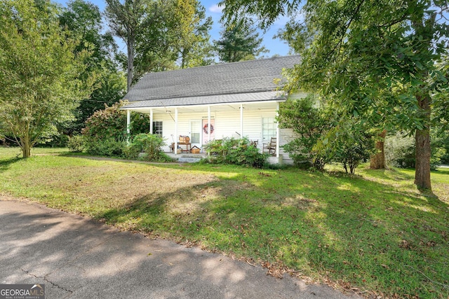 view of property exterior with a lawn and covered porch