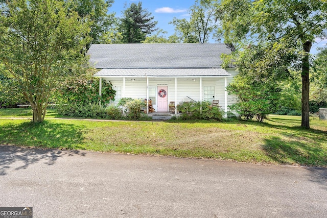 view of front of home with a front yard and a porch