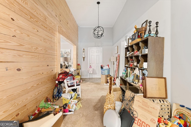 interior space with carpet and wood walls