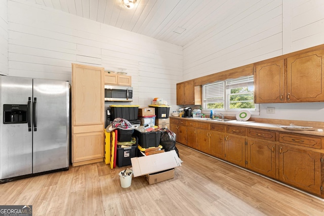 kitchen with sink, appliances with stainless steel finishes, wooden ceiling, a towering ceiling, and light hardwood / wood-style floors