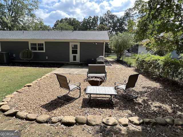 rear view of house with a shingled roof, a patio area, a yard, fence, and cooling unit