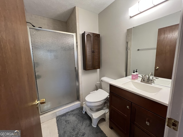 bathroom featuring toilet, tile patterned flooring, a stall shower, and a textured ceiling