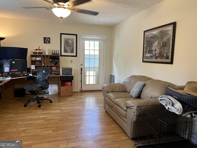 office space featuring ceiling fan, a textured ceiling, and wood finished floors