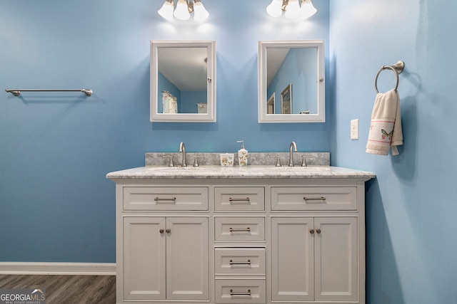 315 Watts Rd, Hiram, GA 30141 - bathroom with double vanity, a sink, baseboards, and wood finished floors